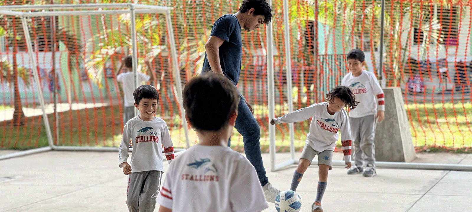 elementary school students play a game of soccer during their break